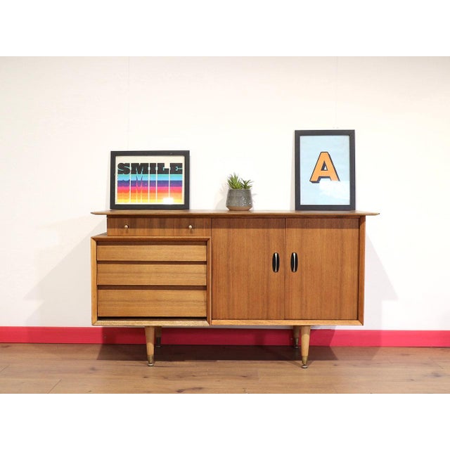 A stunning sideboard made by renowned British furniture maker Beautility, this Mid Century Modern Vintage Teak Credenza...