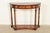 A gorgeous French Empire or Neoclassical style demilune console table In the manner of Maitland Smith USA, Circa Late 20th...