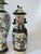 An arresting garniture set of three antique Chinese figural vases, richly decorated with hand-painted warrior and court...