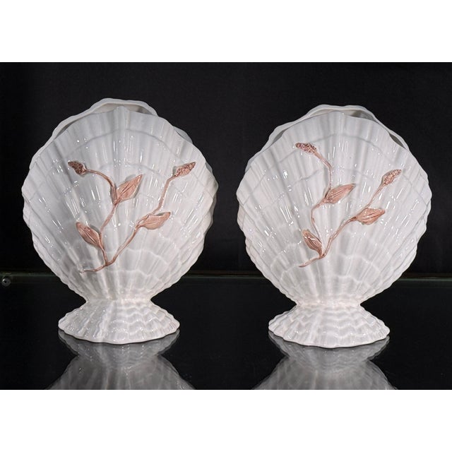 This pair of Italian ceramic cache pots is modeled as large scallop shells on small shell-form feet, finished in a crisp...