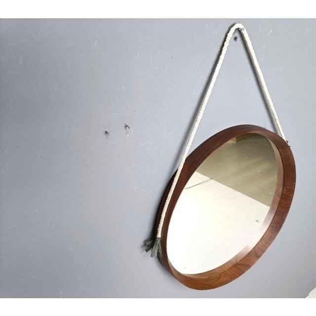 Exquisite and finely crafted teak wall mirror from Italy in the 1960s. Pure quality and timeless design. Comes with its...