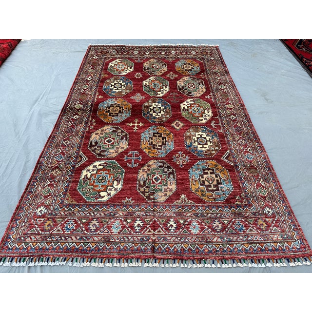 This vibrant Kazak rug features the celebrated Memling gul design: rows of octagonal medallions, each densely patterned...