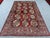 This vibrant Kazak rug features the celebrated Memling gul design: rows of octagonal medallions, each densely patterned...