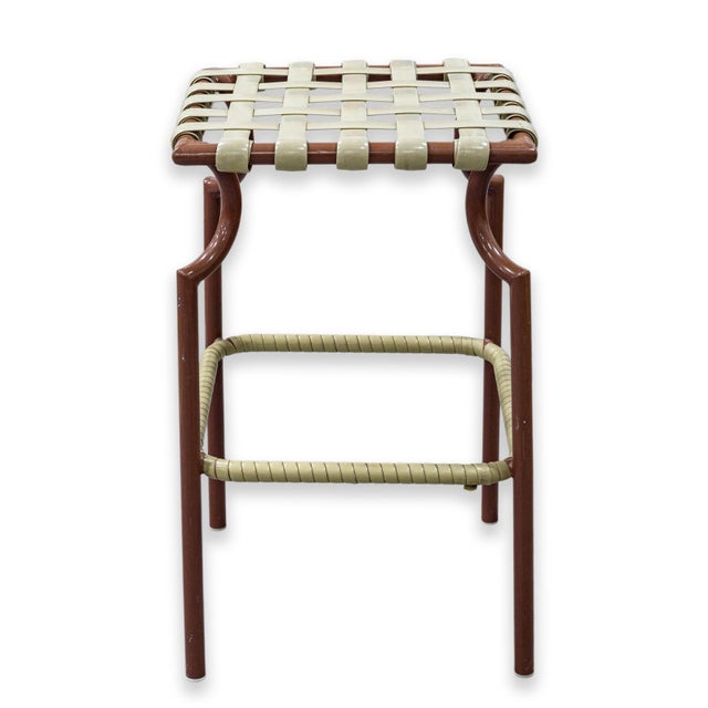 A vintage set of 4 Tropitone woven seat patio stools. These stools feature a tubular metal frame finished in a brown...