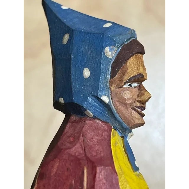 This piece is a very old bottle cap opener attached to a hand-carved and hand painted wooden figurine of a folk-style...