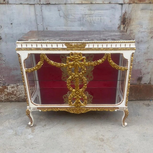 Stunning gold and white vitrine. Has a beautiful gold details in the glass doors. This piece is in great condition and...