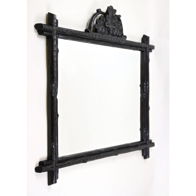 Charming rustic black Forest wall mirror from the late 19th century in Austria around 1870. The lovely design of this...