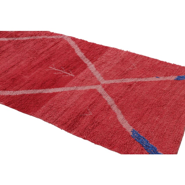 Hand-knotted in wool and originating from Morocco circa 1950-1960, this 3x9 vintage Moroccan rug is a rare and exciting...