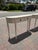 Matching pair of Somerset Bay narrow two-drawer console tables in a soft ivory-white painted finish. Curved ends, turned...