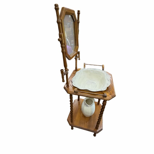 Vintage English country cottage style oak wash stand in natural finish. Features barley twist supports, an octagonal...