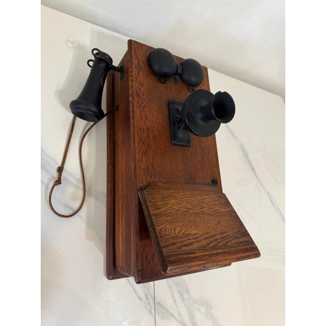 Presenting Antique Wall hanging crank phone comes with wooden body and metal and black Bakelite microphone on headphone....