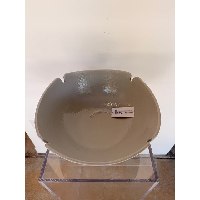 Contemporary ceramic decorative bowl featuring a soft gray finish with a subtle speckled texture and a clean, sculptural...