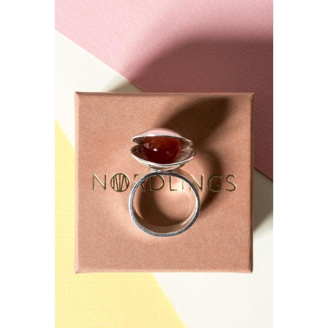 Lovely silver ring by Elis Kauppi, in an imaginative design in the form of a shell. The shell holds a round carnelian...