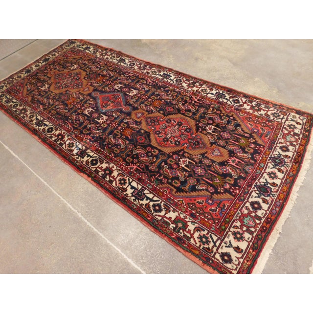 Rich in tone semi antique Persian Gallery rug. Blue field with ivory border. 4'6"x 10'