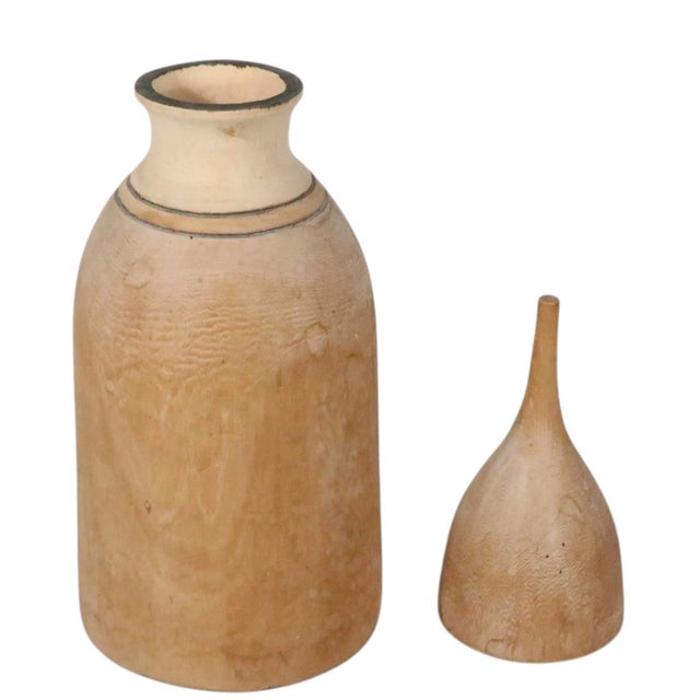 Sculptural wood bottle with an exaggerated pulled form top. We believe this piece is from Burundi, probably Tutsi, or...