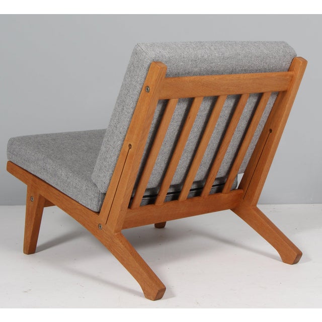 Hans j. Wegner lounge chair with loose cushions new upholstered with light grey hallingdal 130 wool from kvadrat. Frame of...