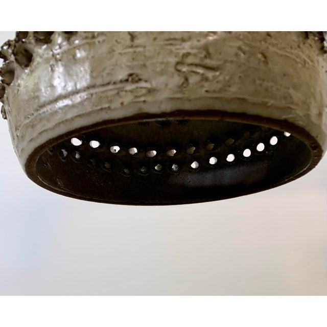 Striking handmade ceramic pendant light from Denmark , crafted in the 1960s–1970s. This bold Brutalist design features a...