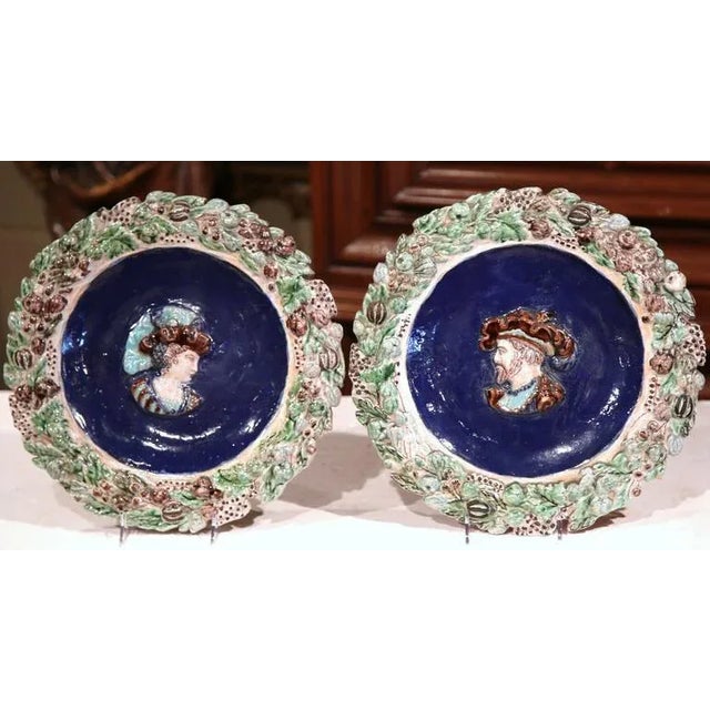 This colorful pair of antique Majolica platters were sculpted in France circa 1850. Both plates, decorated in the...