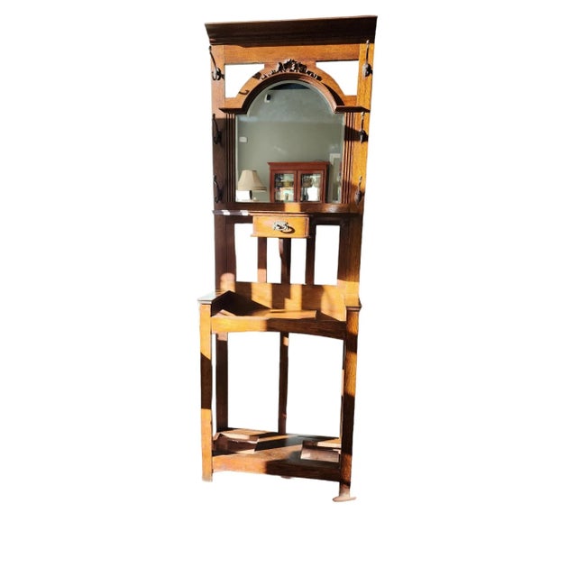 Beautiful 1930s English Edwardian, double shelved, solid oak hall stand with central beveled mirror, central glove drawer,...