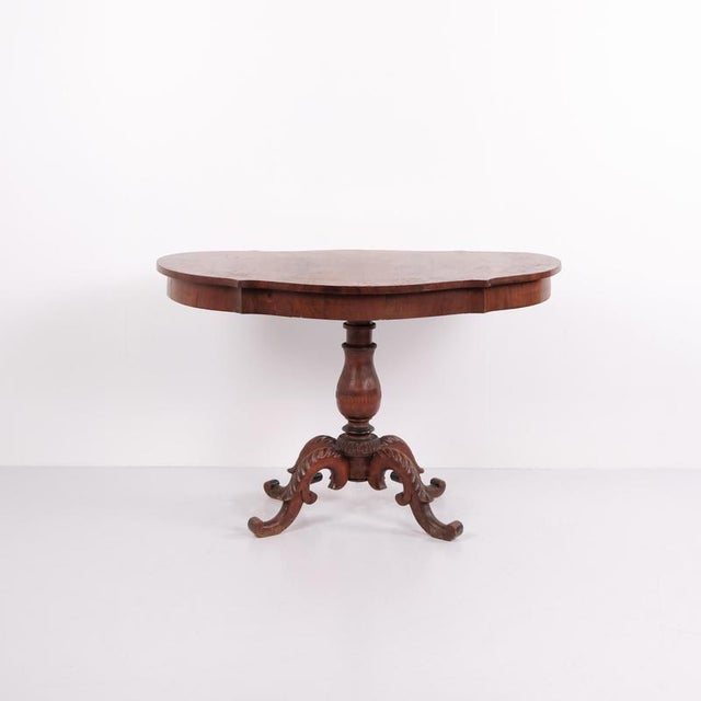 Antique pedestal / serving table from the 19th century, made of mahogany. The table features decorative carved details and...