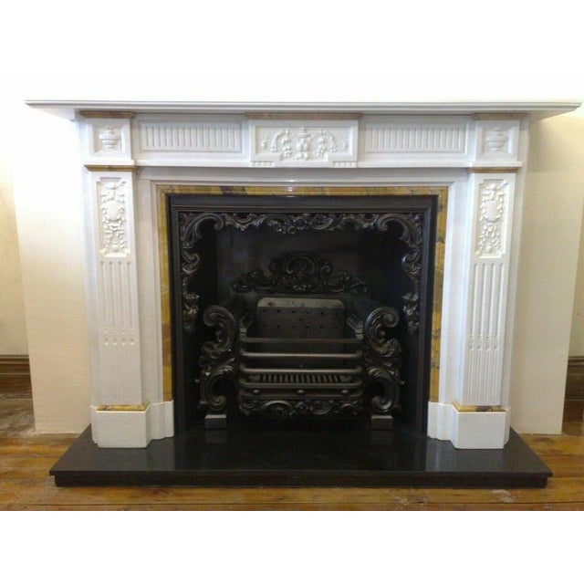 An impressive Georgian carved statuary white marble fireplace surround, beautifully accented with contrasting yellow Siena...