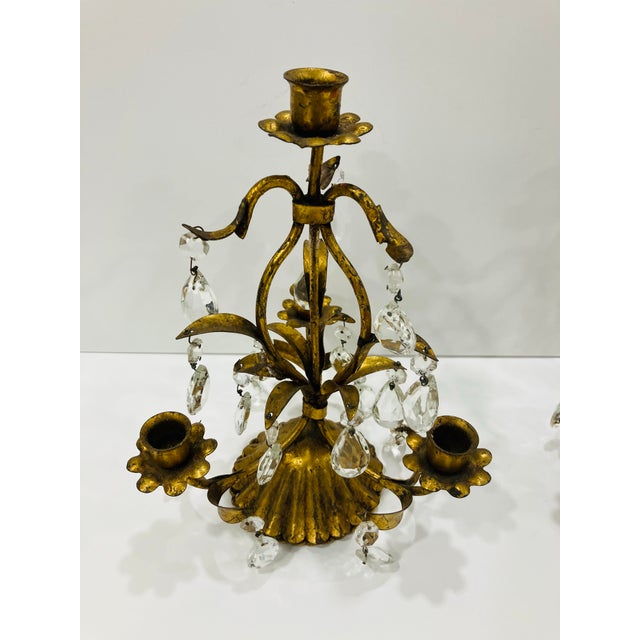 This pair of candelabra was Made in Italy in the 50’s The finish is an antique gold The crystal drops are original Please...