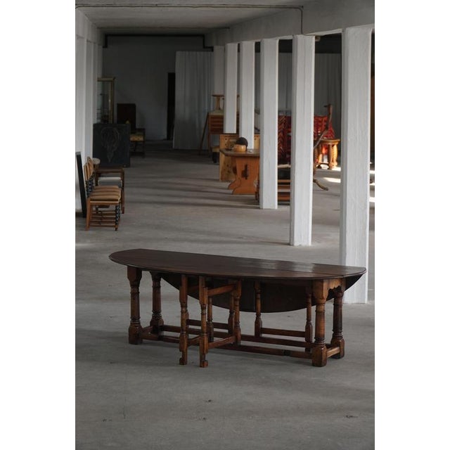 A classic French gateleg dining / console table crafted in solid oak, showcasing the timeless practicality and charm of...