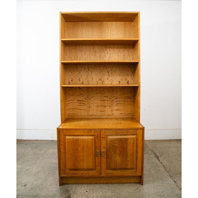Rarely seen Henning Kjernulf 2 piece oak display with adjustable shelving above and cabinet storage below. The bottom...