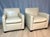 A sophisticated pair of cream leather club chairs by A. Rudin Furniture Company, known for exceptional American...
