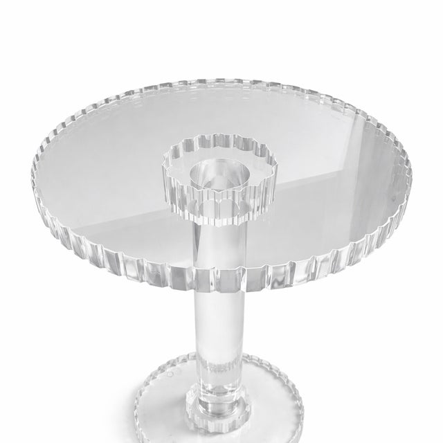 Sleek and sophisticated, this acrylic side table features a clean, minimalist silhouette with a sculptural pedestal base...