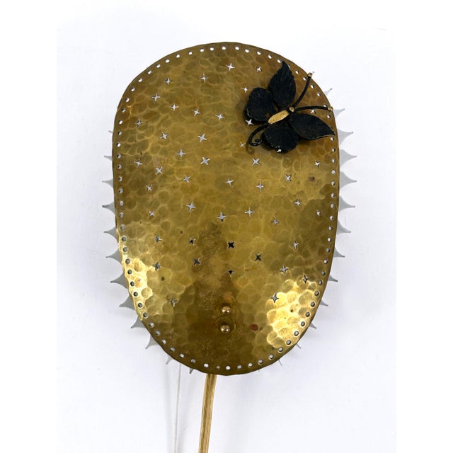 Extremely rare, elegant and highly decorative mid-century modern perforated brass sconce with a papillon figure on the...