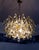 Elegant teardrop chandelier made of clear murano glass drops mounted on a gilt-brass frame. Chandelier illuminates...