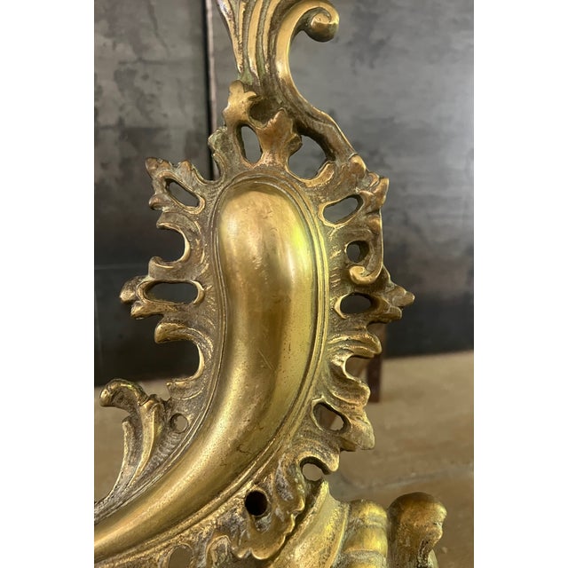 Antique brass andirons made in France in the early part of the 20th century.