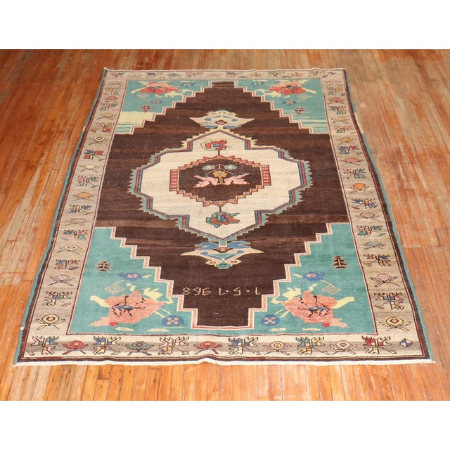 An intermediate-sized Turkish Kars rug in brown and pistachio dated 1968