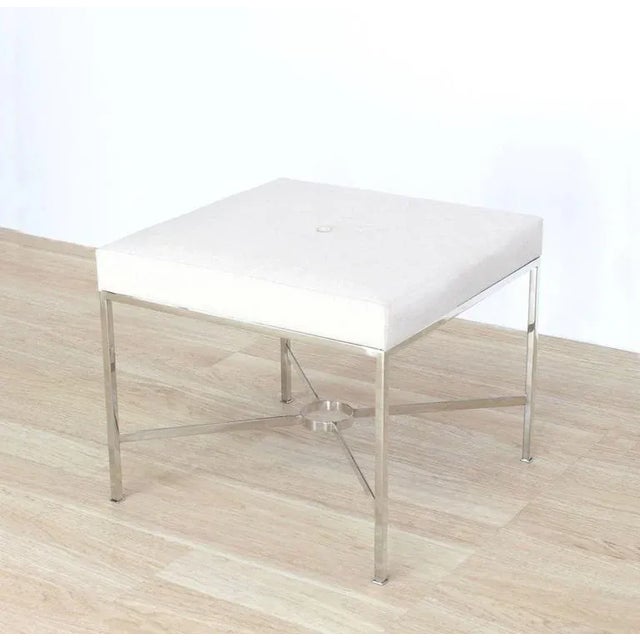 Stainless steel X base bench with fabric upholstery. Perfect for a modern home.