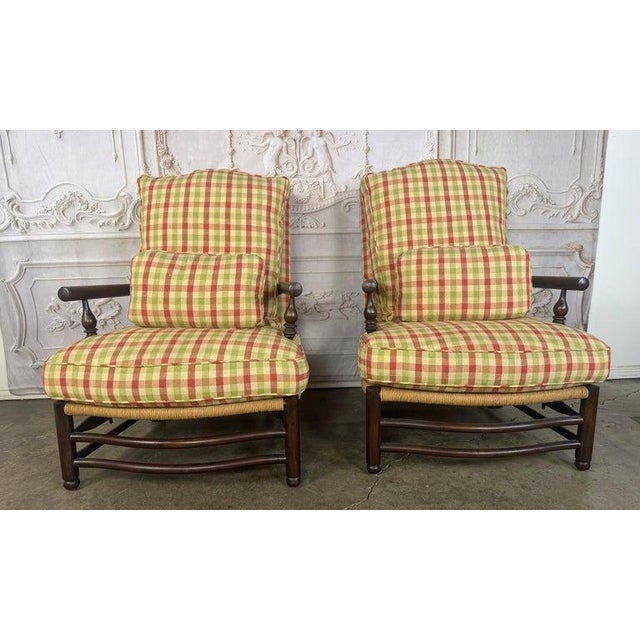 Pair of French Country lounge chairs in the timeless manner of Ralph Lauren Home. This ensemble masterfully blends rustic...