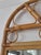 Charming vintage wall mirror with a natural bentwood rattan frame and decorative arched pediment. The openwork crest...