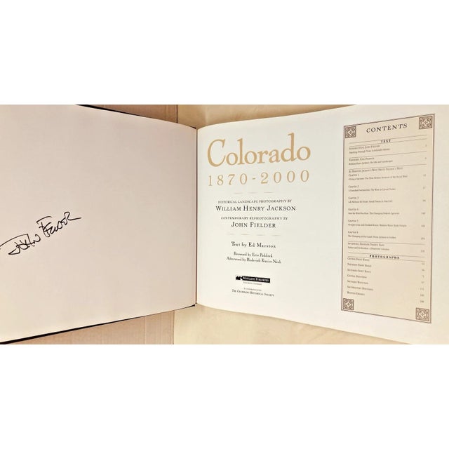 Bound in an elegant brown embossed faux-leather cover with striking gold lettering, this oversized 1999 landscape coffee-...
