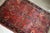 Handmade antique Sarouk rug in red color. The rug is from the beginning of 20th century in original good condition....