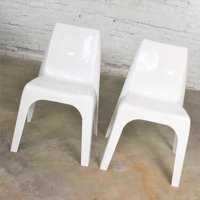 Handsome vintage pair of modern white molded plastic chairs in the style of Kartell’s 4850 chair designed by Giorgina...
