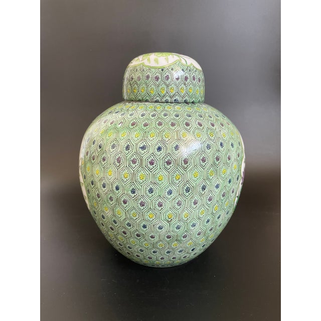 A 20th century Chinese Famille Verte porcelain ginger jar, decorated with an elaborate geometric floral ground framing...