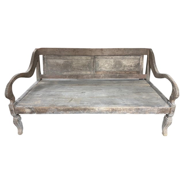 Rare antique teak day bed from the island of Madura. The patina on the wood is stunning. Circa 1900. The length of the arm...