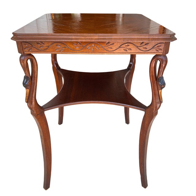 A striking vintage carved swan side table, exquisitely crafted with sculptural avian supports and refined decorative...