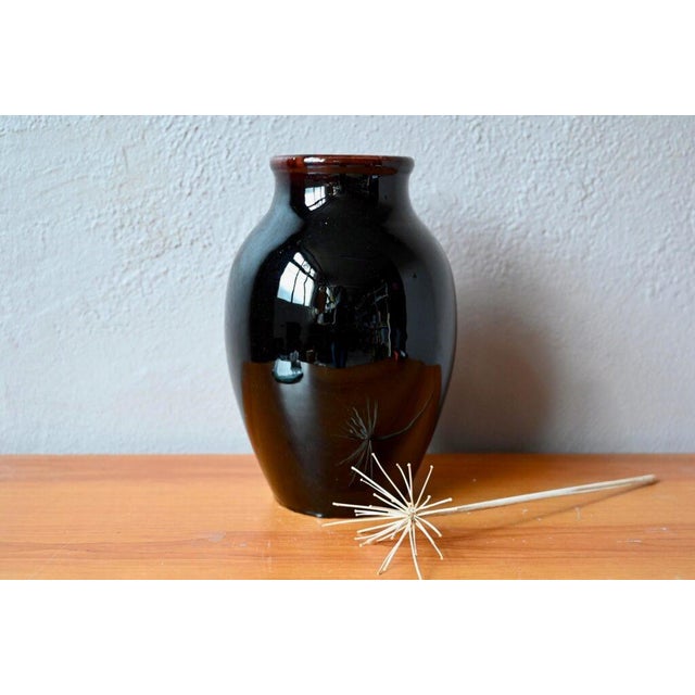 This lovely vase, with its intense, glossy, and striking brown glaze, is a product of the Accolay potters. In the mid-20th...