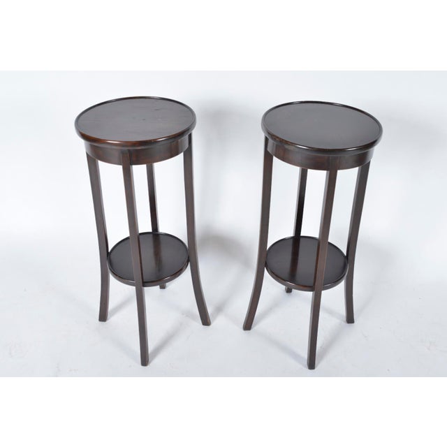 A very elegant, matching pair of antique plant stands / torchieres, each featuring a two-tier display shelf sat on semi-...