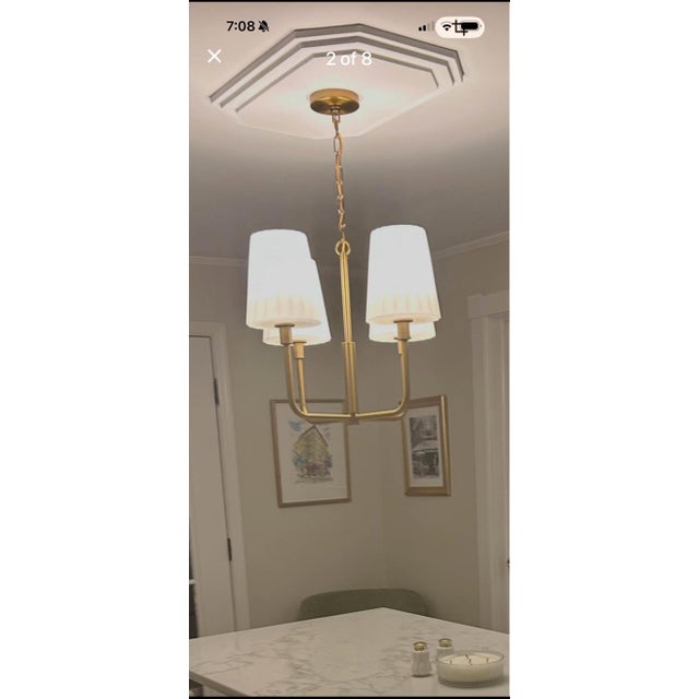 Elegant 4-light chandelier from Alora Mood’s “Plisse” collection, featuring an aged brass finish and tailored pleated...