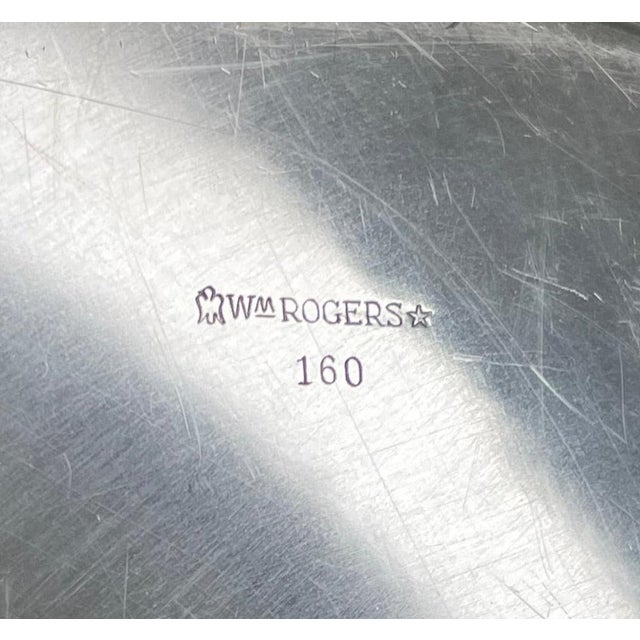 This 12-inch W. M. Rogers medium silver plate tray combines classic craftsmanship with practical size, making it ideal for...