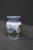 Porcelain vase with hand-painted lotus and foliage design. Classic baluster form with flared rim. Blue and white border...
