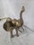 Vintage large brass elephant sculpture featuring a raised trunk, extended ears, curved tusks, and dimensional hand-...