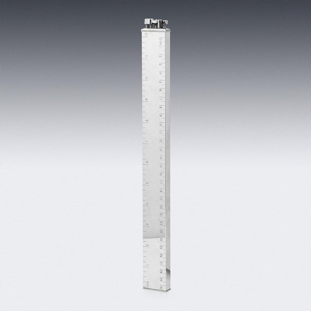 An extremely stylish 20th century silver plated novelty table lighter in the form of a 12 inch ruler calibrated in both...